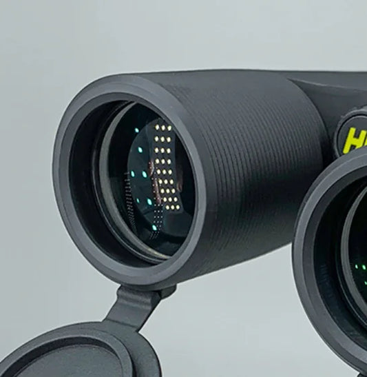 Close-up of a black binoculars with a visible brand logo on a light gray background