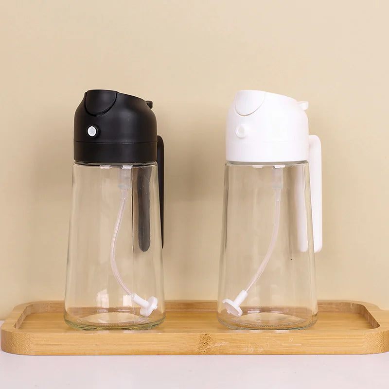 Two clear glass bottles with black and white lids on a wooden tray against a beige background